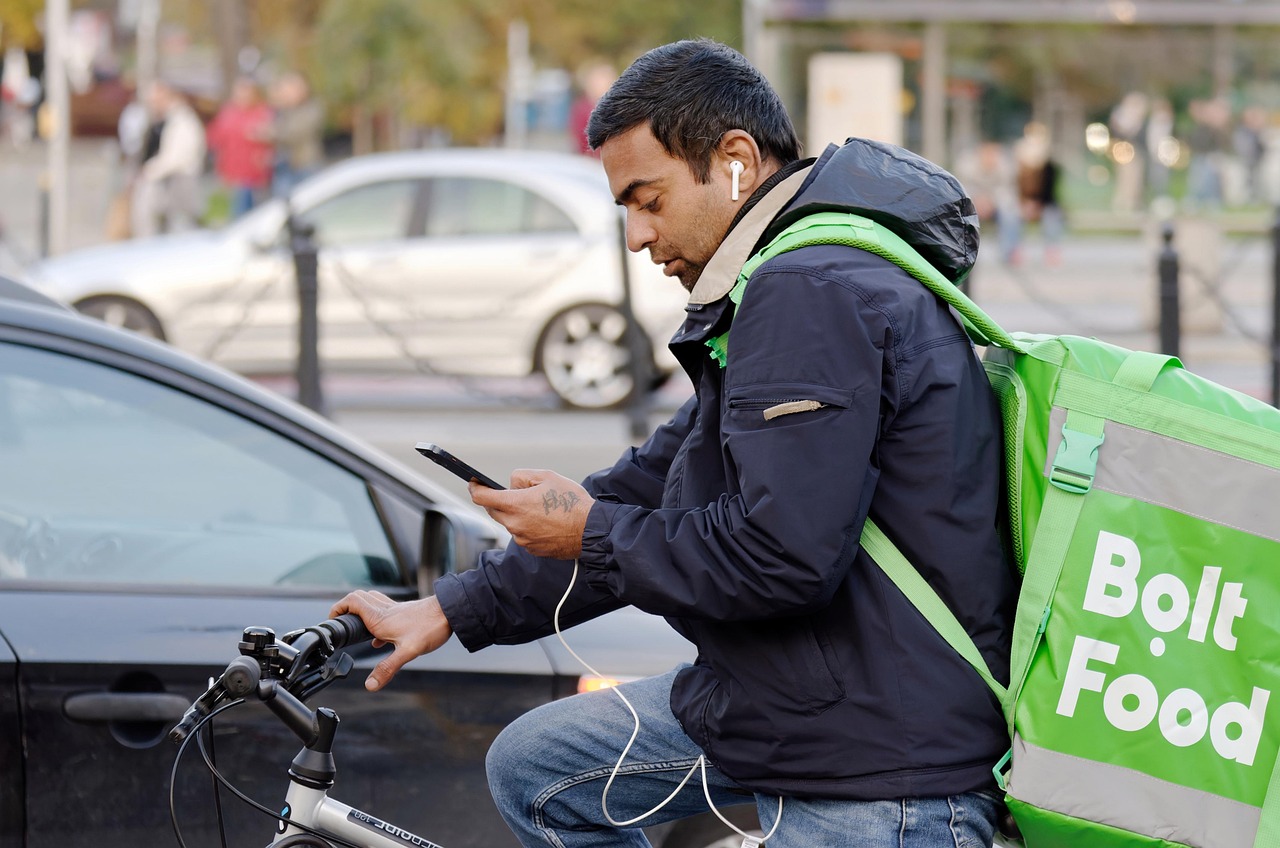 man, bicycle, food delivery, delivery rider, smartphone, phone, delivery, service, courier, transport, traffic, cars, urban, city, job, snapshot, street photography